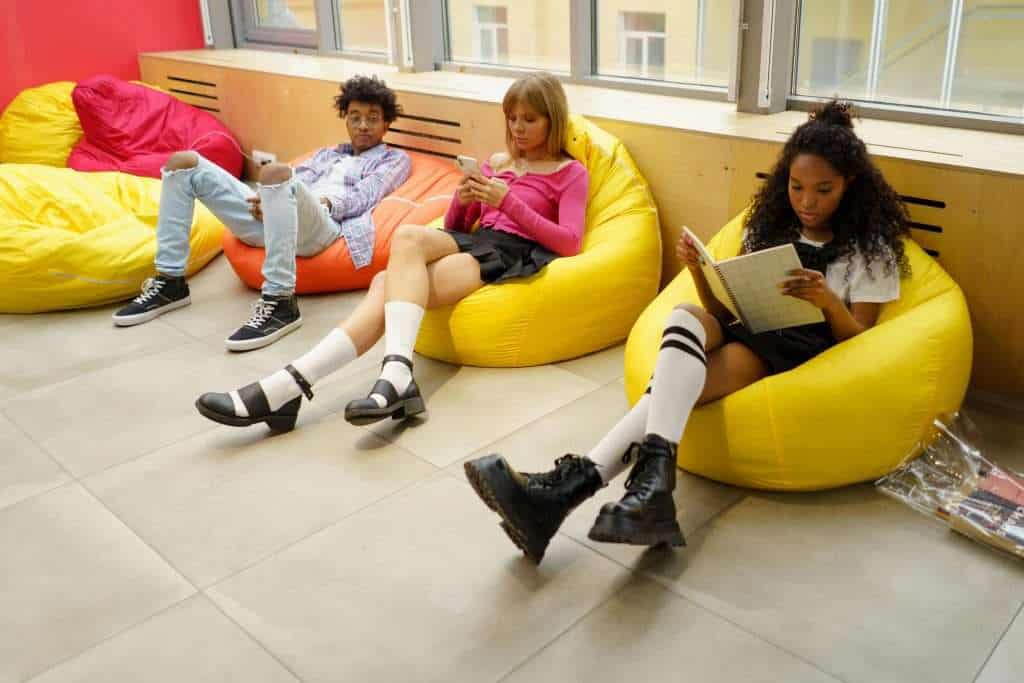 Three teenagers relaxing together in a safe, comfortable environment during a Regulation 44 visit.